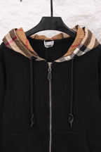 Black zip hoodie with plaid-lined hood, front zipper, and drawstrings