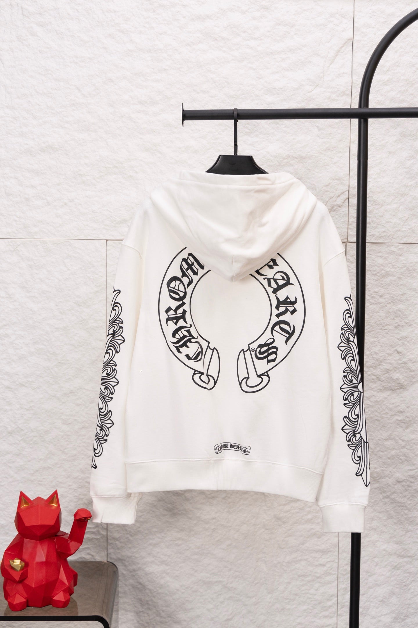 White zip-up hoodie back view with large circular graphic and vertical sleeve artwork