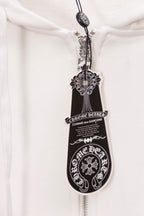 White hoodie zipper pull with ornate crest and shield design