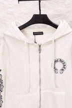 White zip-up hoodie close-up with hood, front zipper, and chest logo patch
