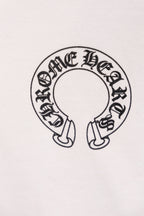White hoodie close-up of circular emblem graphic with small footwear icons
