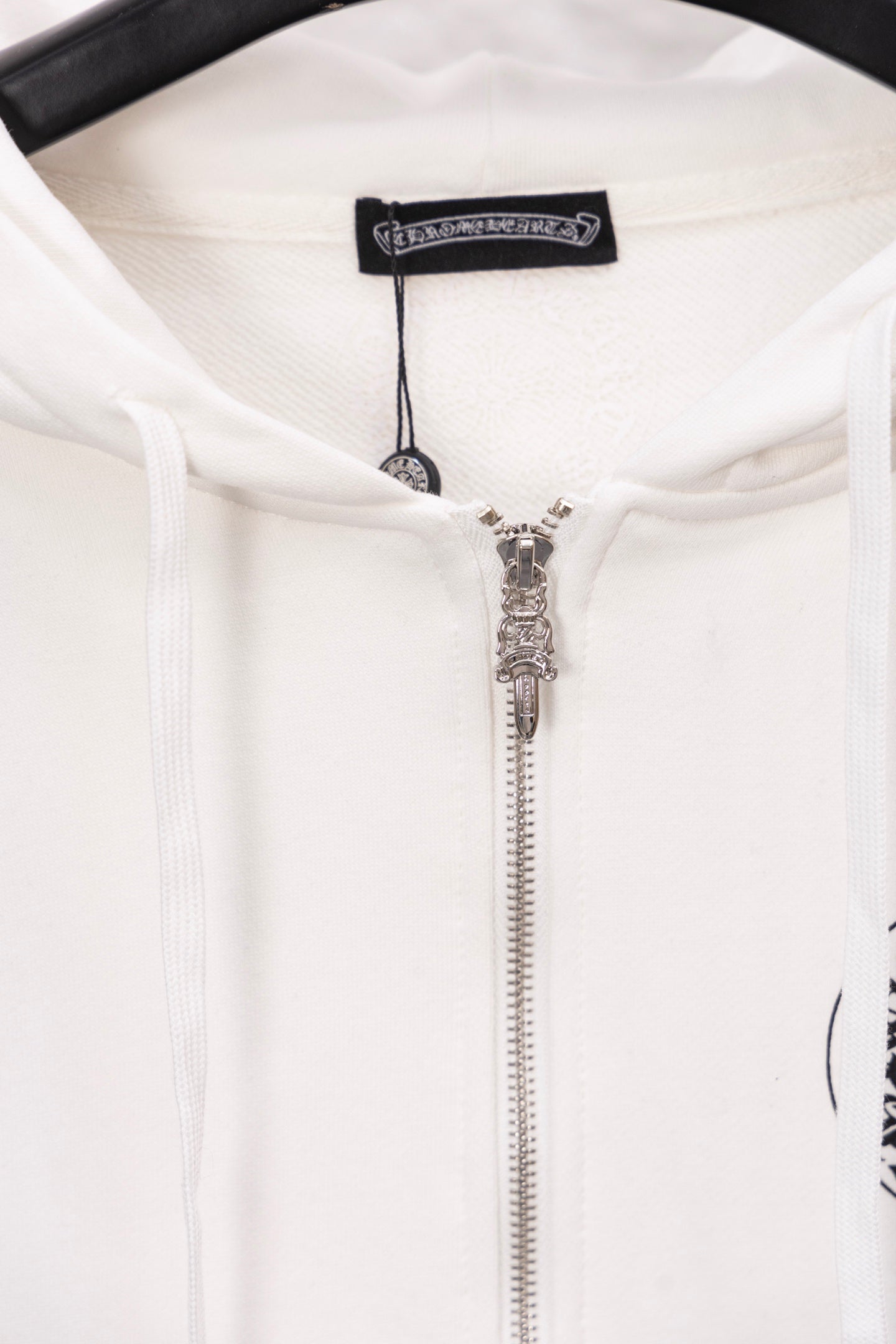 White long-sleeve zip hoodie with silver zipper and drawstring hood