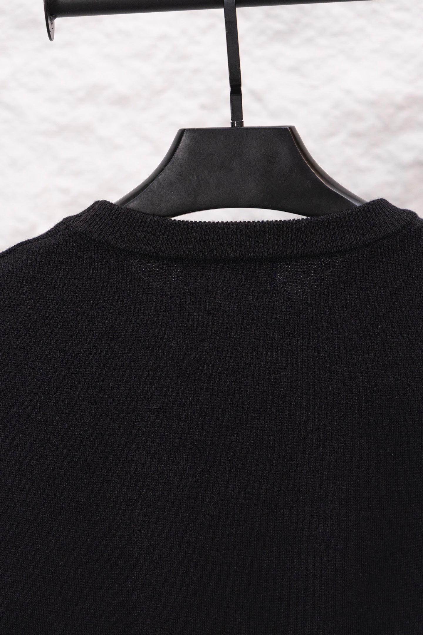Black long-sleeve sweatshirt ribbed crew collar, no visible front graphics