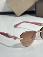 Bvlgari sunglasses with pink temples and jeweled hinge on gold-tone frame