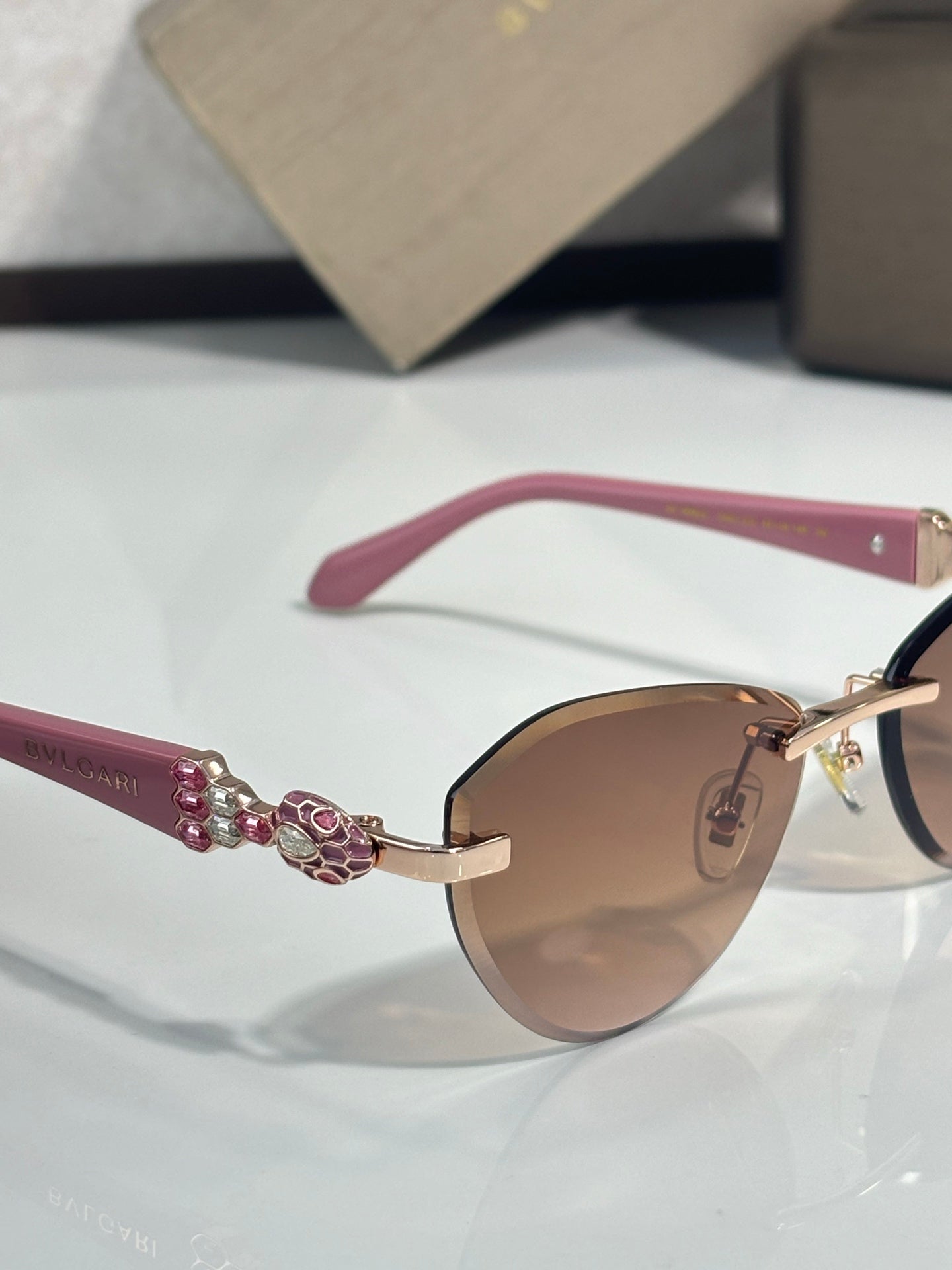 Bvlgari sunglasses with pink temples and jeweled hinge on gold-tone frame