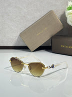 Bvlgari sunglasses with light tan lenses and gold-tone frame with jewel accents