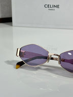 Purple-tinted oval sunglasses with gold frame and dark lenses