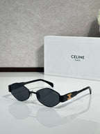Black cat-eye sunglasses with dark lenses and gold-tone logo detail