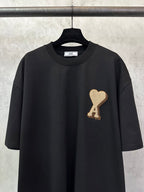 Black T-shirt with crew neckline and heart "A" appliqué detail on the chest