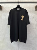 Black T-shirt with heart-shaped "A" appliqué on the chest, short sleeves