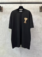 Black T-shirt with heart-shaped "A" appliqué on the chest, short sleeves