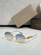 Bvlgari round sunglasses with pale blue lenses and gold metal frame