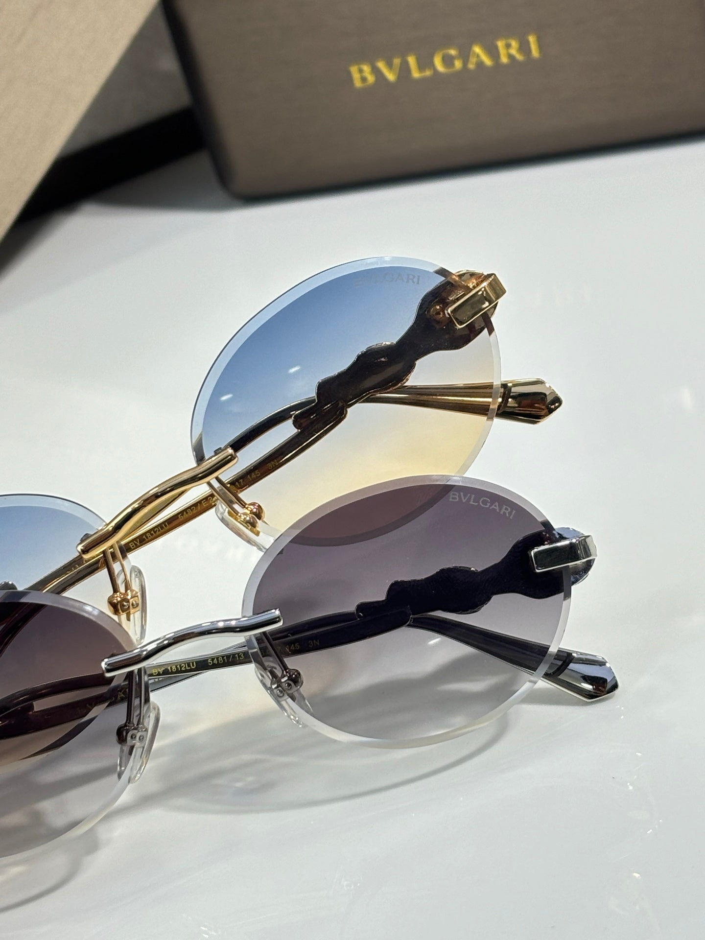 Bvlgari round sunglasses with gold frame and blue mirrored lenses