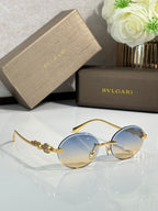Bvlgari round sunglasses with blue lenses, gold metal frame and ornate temples