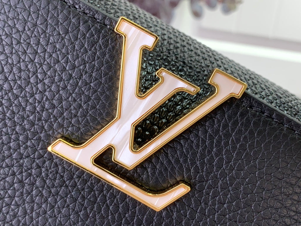 Louis Vuitton LV gold logo plaque on black textured leather handbag