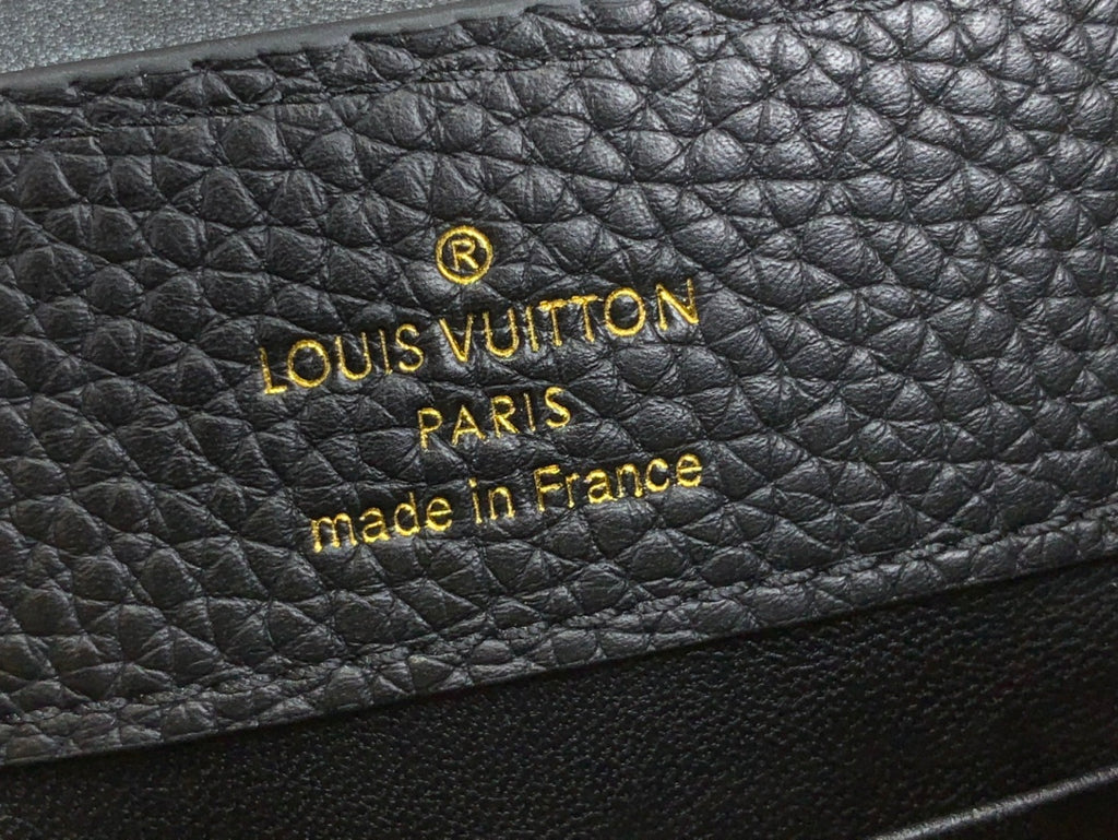 Louis Vuitton label on black textured leather: PARIS made in France