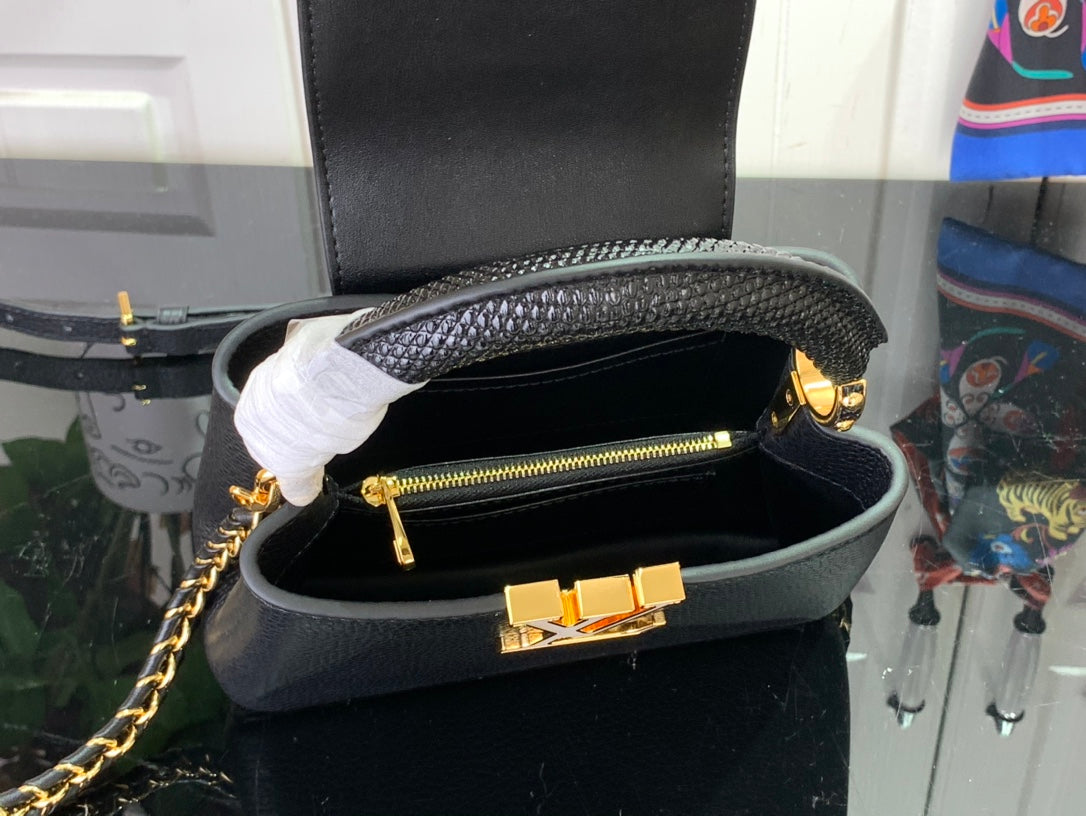 Louis Vuitton black handbag open with gold zipper and inner hardware