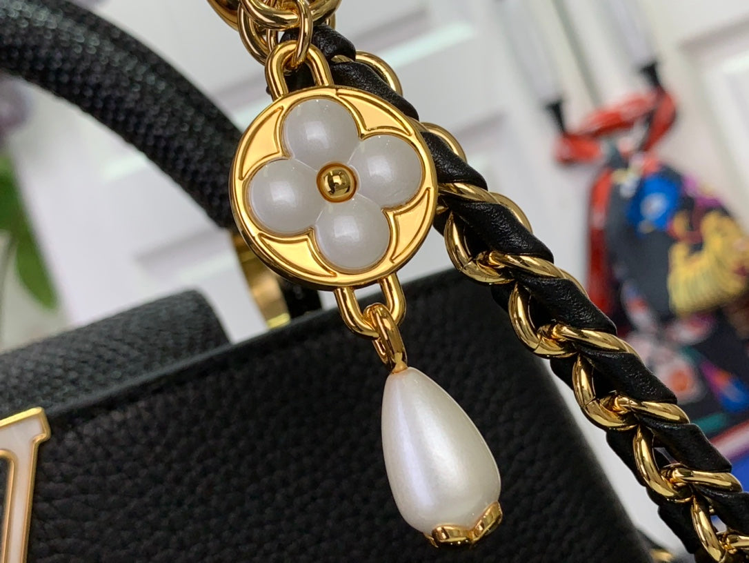 Louis Vuitton chain strap with gold clover charm on black textured leather bag