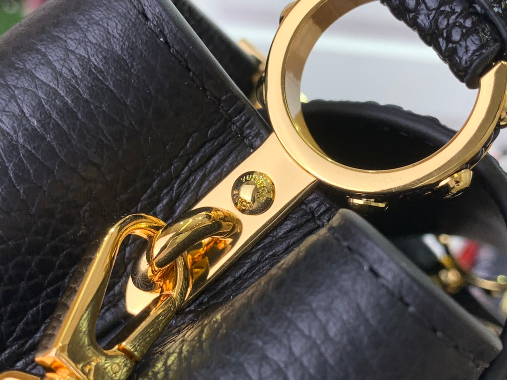 Louis Vuitton gold clasp ring on black leather strap with hardware detail