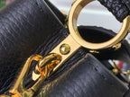 Louis Vuitton gold clasp ring on black leather strap with hardware detail