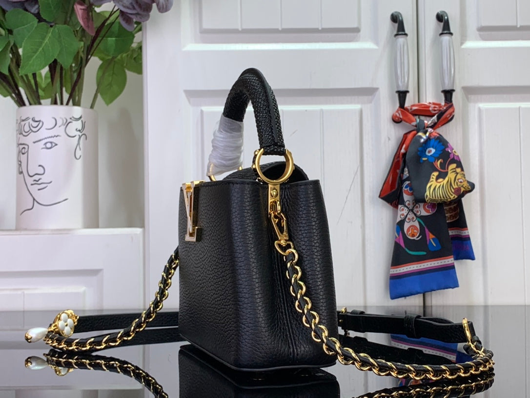 Louis Vuitton black structured handbag with gold hardware and chain shoulder strap