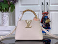 White textured handbag with gold LV emblem, top handle, and thin shoulder strap