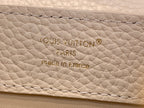 Embossed text on white leather: Louis Vuitton, Paris, made in France