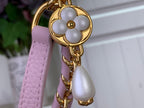 Louis Vuitton bag strap detail, light pink leather with gold clasp hardware