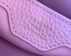 Louis Vuitton card slot on light pink leather, Louis Vuitton Paris text, stitched