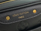 Louis Vuitton interior logo patch on dark leather with gold stamped text