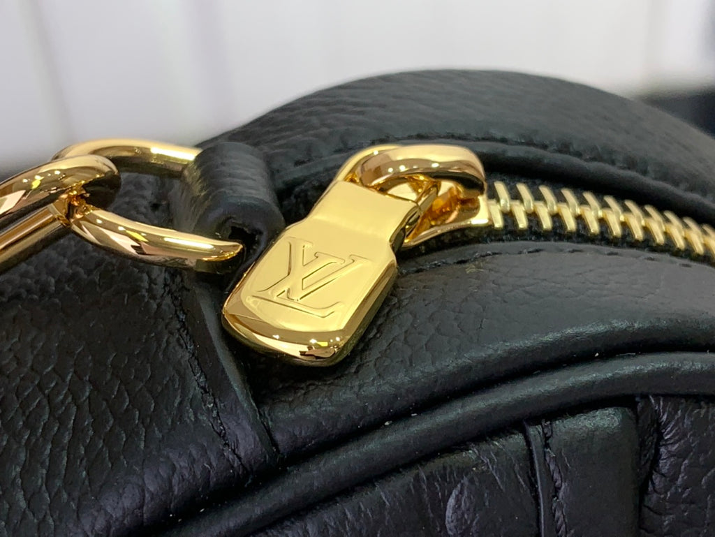 Louis Vuitton zipper pull on dark leather with gold-toned hardware