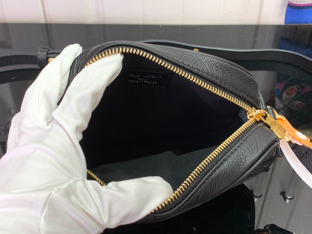 Louis Vuitton crossbody bag interior, gold zipper and dark fabric lining