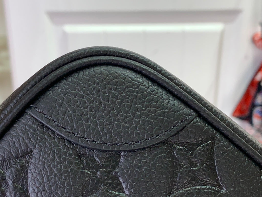 Louis Vuitton embossed leather corner with monogram pattern and stitched trim