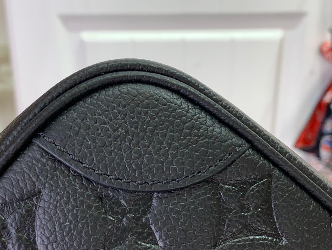 Louis Vuitton embossed leather corner with monogram pattern and stitched trim
