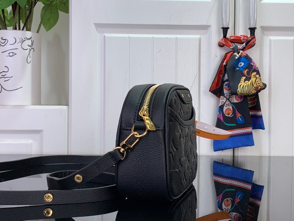 Louis Vuitton monogram crossbody bag, dark leather side view, gold clasp and strap