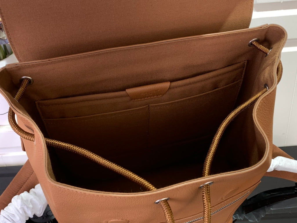 Louis Vuitton men’s flap backpack interior with zip pocket and tan lining