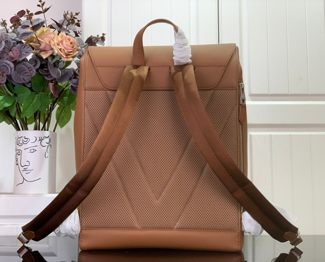 Louis Vuitton tan leather backpack back view with perforated panel and adjustable straps