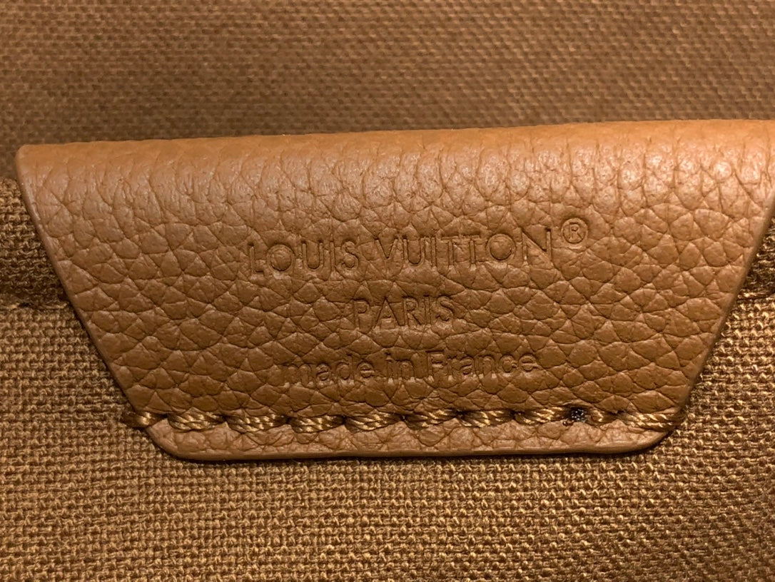 Louis Vuitton logo patch on tan leather flap with stitched edge