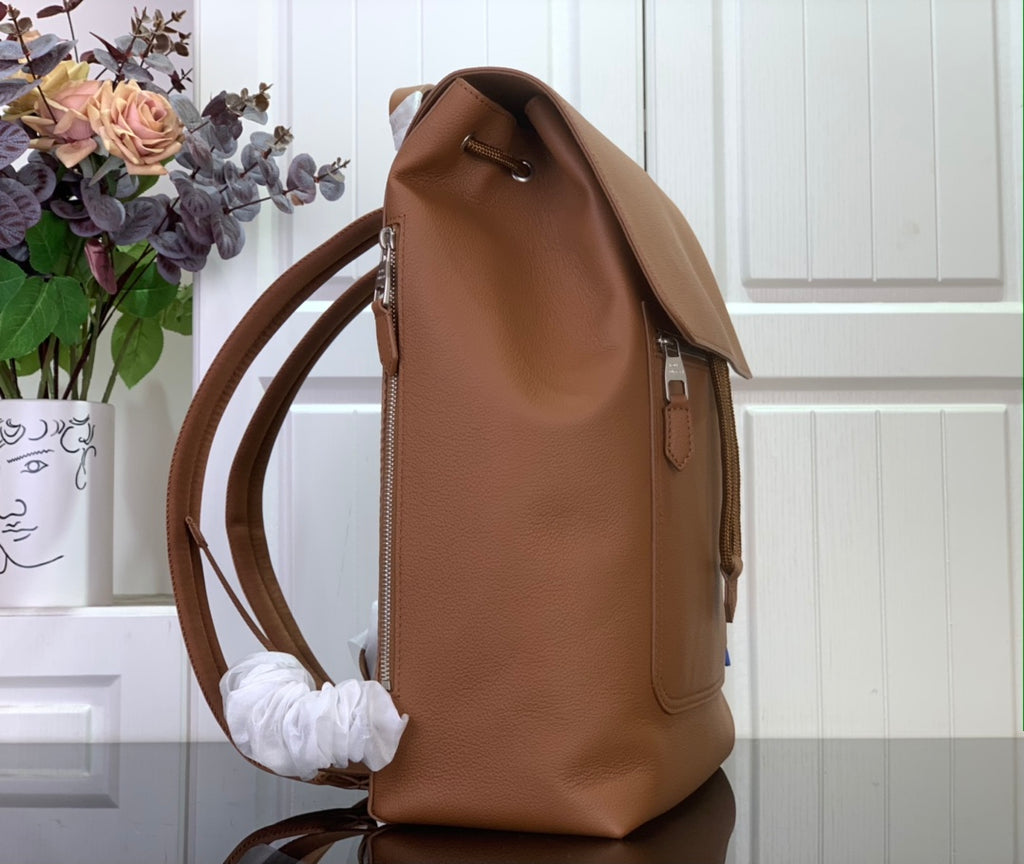 Louis Vuitton men’s side view flap backpack in tan leather with shoulder strap