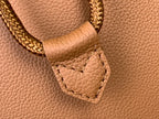 Tan leather Louis Vuitton strap detail with braided trim and stitched pocket