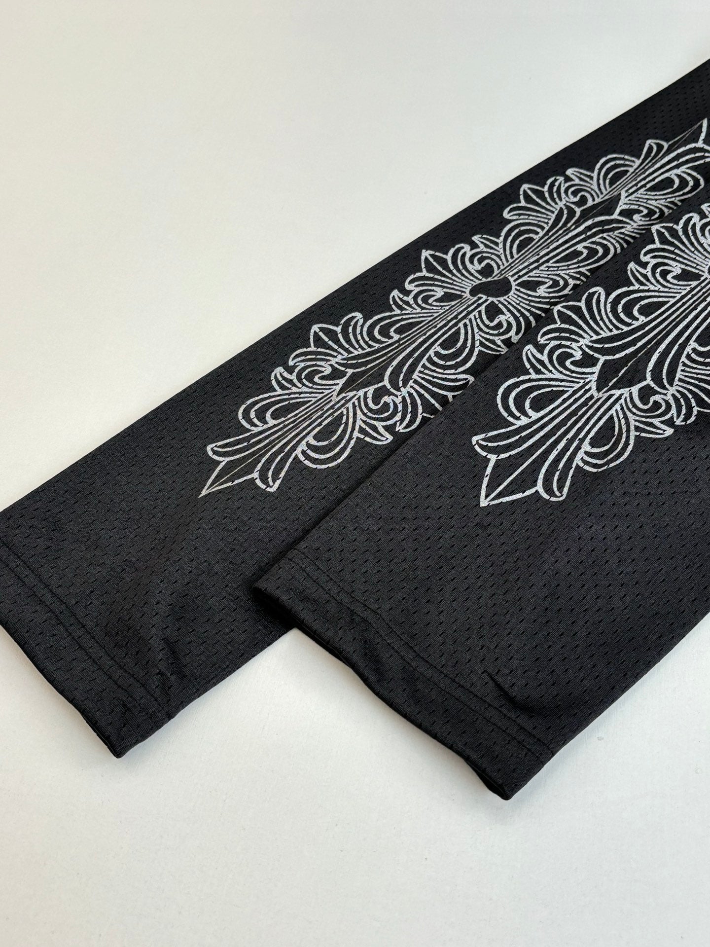 Chrome short jogger pant leg with dark charcoal embroidered-style side feather graphic