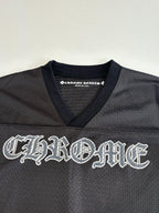 Chrome short long-sleeve jersey top front close-up with large embroidered-style logo in dark charcoal