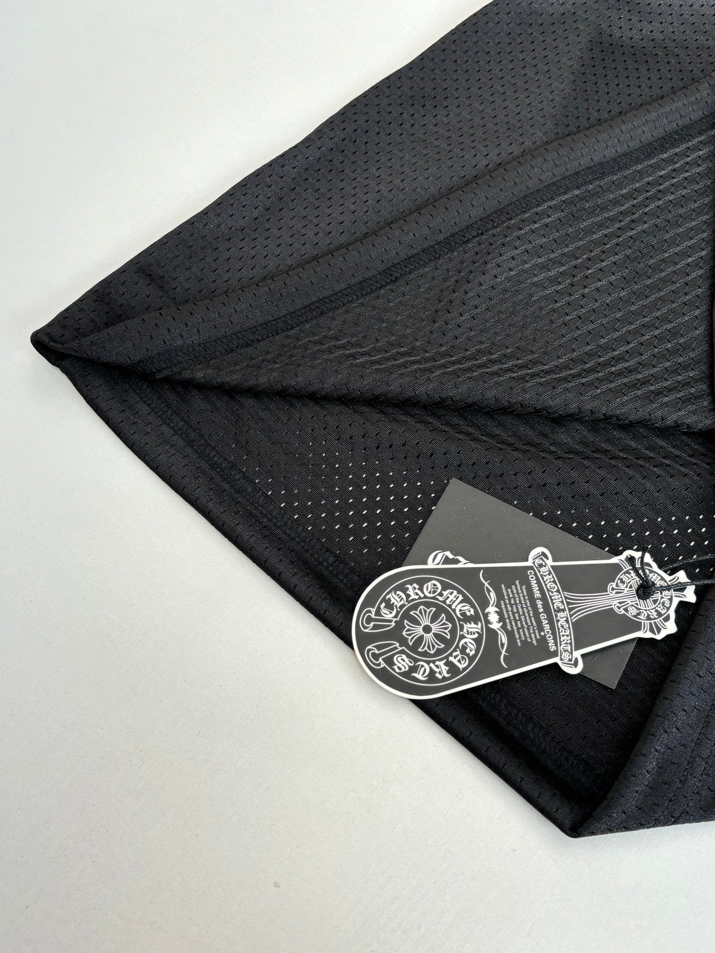 Chrome short jogger pants with dark charcoal fabric and small printed logo patch near hem