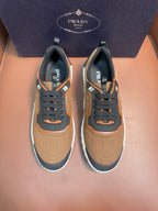Tan and black lace-up sneakers with orange trim and chunky rubber sole, Prada logo detail