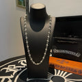 Silver ball chain necklace, with round links and clasp at the front.