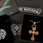 Gold tone cross pendant necklace in a display box with beaded chain