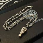 Silver-tone layered chain necklace with teardrop pendant charms on black tray