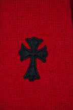 Red sweater with black cross applique embroidered on the front