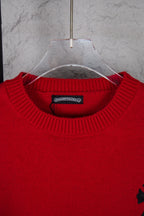 Red crewneck sweater close-up with ribbed collar and neckline label