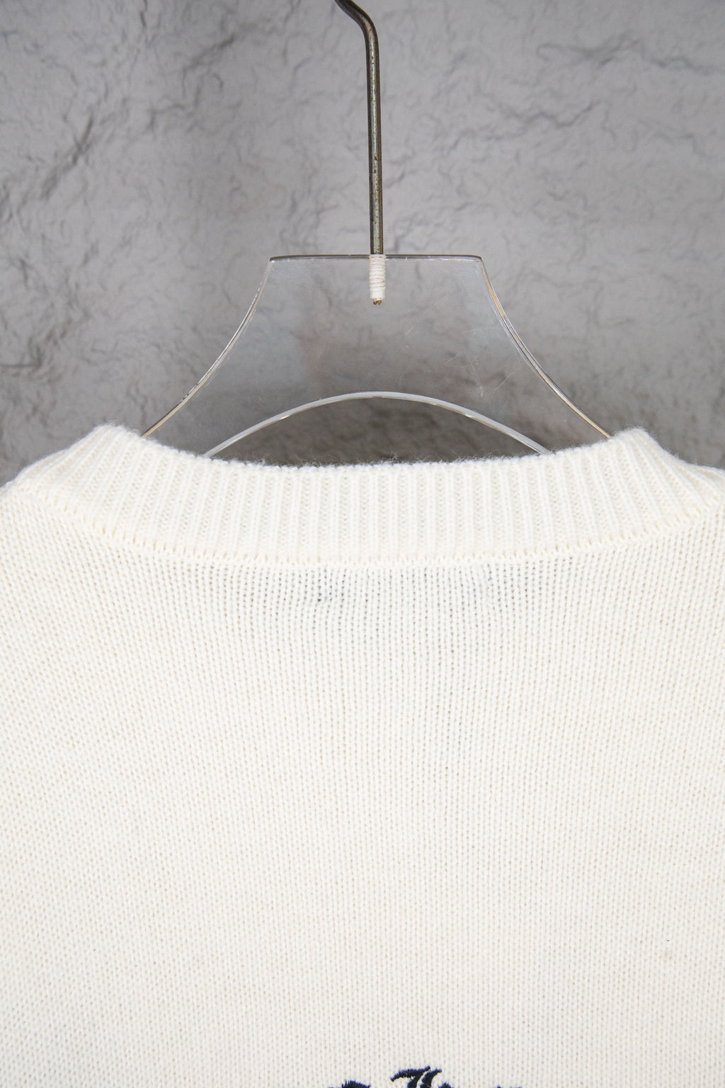 Cream knit sweater back with crewneck collar ribbing